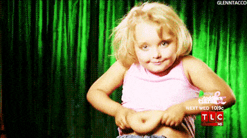 TV gif. A smiling Honey Boo Boo grabs her stomach.