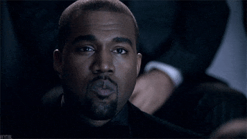 Celebrity gif. Kanye West is watching something and he has a straight expression on his face but his eyes slowly blink as he mouths, "What the fuck."