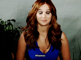 Celebrity gif. Brunette Jennifer Lawrence wears a lowcut cobalt blue dress as she disinterestedly rolls her eyes and tosses her head, saying, "Whatever."