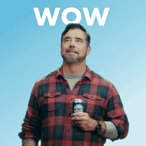 Sponsored gif. Gerald Downey wearing a red and black plaid shirt holding a can of Busch Light beer at his chest. He looks up with wonder and appreciation, taking a long, deep breath as if he's taking in the beautiful mountain scenery. Text, "TGIF."