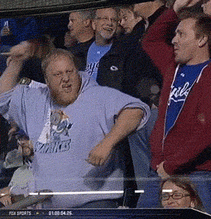 Sports gif. A man in the crowd at a sports game looks at us as he pumps his arms up. He rotates his hips and his hoodie rides up to show his belly flopping around as he dances. 