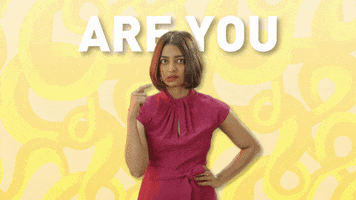 Celebrity gif. Radhika Apte has a hand on her waist and she is wide eyed as she twirls one hand around her temple in the crazy symbol. Text, "Are you mad!"