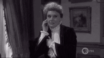 SNL gif. Kate McKinnon, in black and white and dressed in 1800s-style clothes, grimaces and shrugs slightly, her eyes squinting. She moves her hand in a "whatever" motion, obviously concerned but willing to do nothing about it.