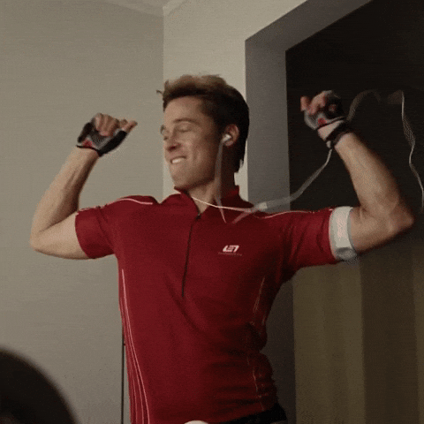 Movie gif. Brad Pitt as Chad in Burn After Reading listening to an iPod and dancing, pumping his arms, snapping his fingers, and biting his lip.