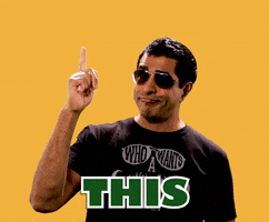 Video gif. Against a sunflower yellow background, a confident guy wearing aviator sunglasses and a smirk points up toward the sky. Text, "This," in all caps.