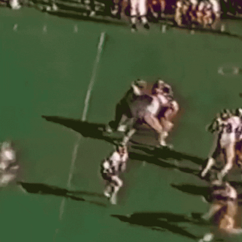 Video gif. Old footage of Herschel Walker during a University of Georgia game shows him running the football as he artfully dodges his opponents. As he runs, various notes are written on the screen. First, Herschel Walker is pointed out. His first dodge is labeled, “Herschel ducking facts.” His second dodge is labeled “Herschel dodging debates.” Then, a pile of football players tackles him, and the label reads, “All of us stopping Herschel on election day.”