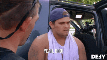 Reality TV gif. A man on Dog The Bounty Hunter stands at the open door of a truck wearing his shirt half on around his neck and a backwards hat. He looks uncomfortable as he looks down and says with a nod, "Yeah, bro! Please!"
