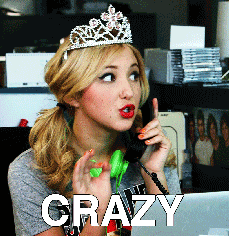 Celebrity gif. Actress Audrey Whitby gossiping on the phone, saying the word "crazy" with great emphasis. She is in an office cubicle wearing a tiara.