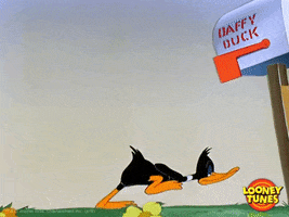Cartoon gif. Daffy Duck from a classic Looney Tunes cartoon paces back and forth behind a mailbox with his name on it. His back completely parallel to the ground and a dreary, bored look on his face. He then stands upright, crossing his arms, and tapping his foot with an irritated expression.
