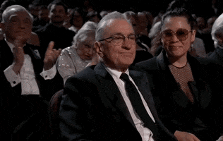 Oscars 2024 GIF. Robert De Niro, seated at the Oscars, disinterested and inscrutable.