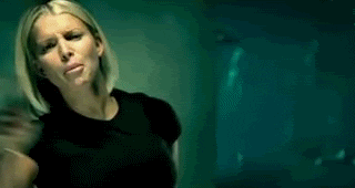Celebrity gif. Jessica Simpson in a desolate empty room looks furious, sad, and scary, frowning and yelling and shaking her fist, pulling back her hair.