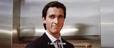 Movie gif. Christian Bale as Patrick in American Psycho smirks as she nods his head. Text, "I don't know."