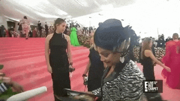 Celebrity gif. Comedian Tiffany Haddish on the 2019 Met Gala red carpet reveals the contents of her clutch and says "That chicken in the bag!"