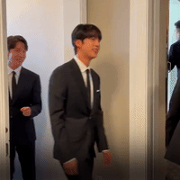J-Hope and Suga walk out of the press conference.
