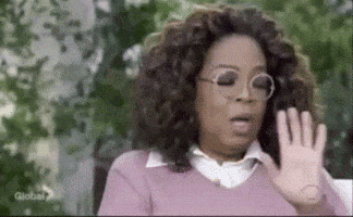 Celebrity gif. Oprah Winfrey holds her hands out to signal to stop. She turns her head and says, “Hold it!”