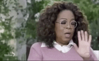 Celebrity gif. Oprah Winfrey holds her hands out to signal to stop. She turns her head and says, “Hold it!”