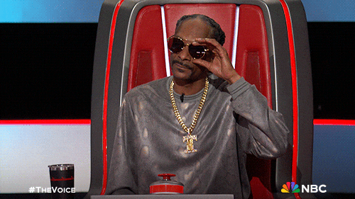 Snoop Dogg lifting his sunglasses to take a second look