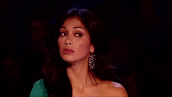 TV gif. On an episode of "X Factor," judge Nicole Scherzinger turns her head to the side and looks at the stage with wide eyes, skeptical.