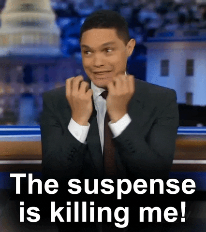 TV gif. Trevor Noah holds his bunched fists under his chin in excitement and says "The suspense is killing me!"