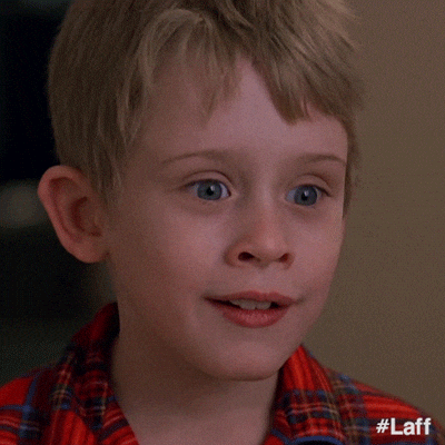 Movie gif. Macaulay Culkin as Kevin in Home Alone looks surprised, then turns toward us and smiles with his eyebrows raised.