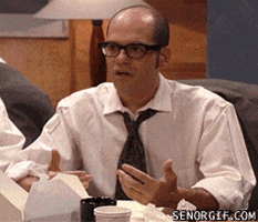 TV gif. David Cross on Mr. Show with Bob and David sits in a work meeting and exclaims, "What the fuck?" while looking around him in angry disbelief. His palms face upwards to emphasize his confusion.