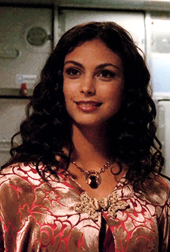TV gif. Morena Baccarin as Inara from Firefly smiles sweetly.