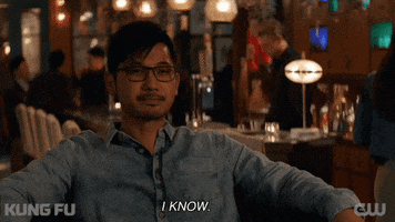 TV gif. Jon Prasida as Ryan Shen on the show Kung Fu sits comfortably in a chair at what looks like a restaurant. He nods his head and confidently smiles as he says, “I know.”