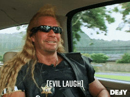 Reality TV gif. Duane Chapman in Dog the Bounty Hunter wears sunglasses as he opens his mouth wide and covers it with his hand as if yawning. Text, in brackets, "Evil laugh."