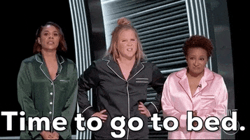 Celebrity gif. Regina Hall, Amy Schumer and Wanda Sykes wear matching pajama sets of different colors on stage at The Academy Awards in 2022. Amy says, "Time to go to bed."