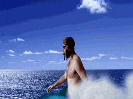 Video gif. Man in a trapper hat wearing no shirt rides on a dolphin in the ocean. He coolly whips off his sunglasses and looks at us to say, “Happy birthday!”