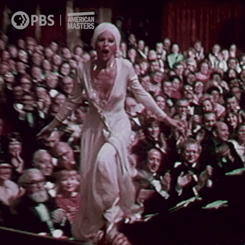 Celebrity gif. Rita Moreno ecstatically runs onstage at the Tony Awards to accept her award. When she hits the stage, she mimes an imaginary lasso, leaning back and whipping it as she approaches the podium.