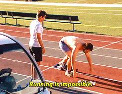 Parks and Recreation gif. Chris Pratt as Andy, shirtless, goes from a start position to lying facedown on a running track while Rob Lowe as Chris stands by and looks on. Text, "Running is impossible."