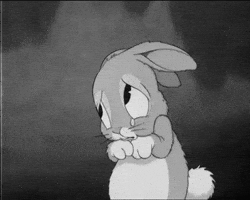 Cartoon gif. In black and white, a sad rabbit looks pitiful while tears fall to the floor.