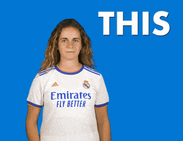 Video gif. Real Madrid Football player Teresa Abelleira looks up and points at the text, "This".