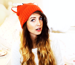 YouTube content creator Zoella wearing a fox beanie making a "rawr" reaction face