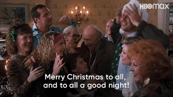 Movie gif. Chevy Chase as Clark in "National Lampoon's Christmas Vacation" wears a Santa hat, gathered with family members, and joyously shouts "Merry Christmas to all, and to all a good night!"