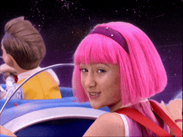 TV gif. Julianna Rose Mauriello as Stephanie in Lazy Town rides in a flying ship, looking over her shoulder at us and smiling.