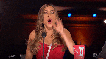 TV gif. Wide-eyed Sofia Vergara points toward us from her judge's seat on America's Got Talent with her mouth open in shock.