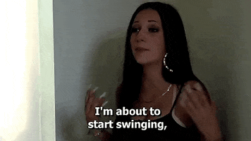 Celebrity gif. Bhad Bhabie is very frustrated as she talks to someone and says, "I'm about to start swinging,"