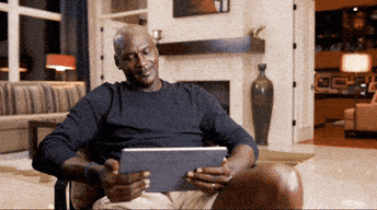 Michale Jordan looking a the tablet and laughing