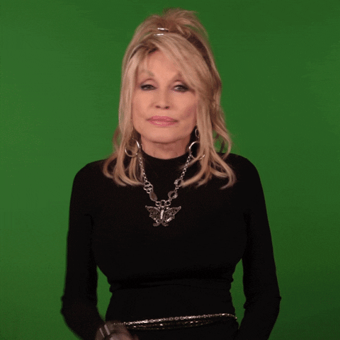Celebrity gif. Dolly Parton shakes her head and wags her finger as if saying no way. 