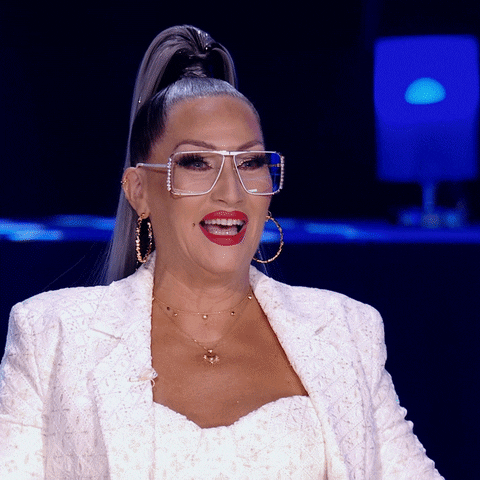 TV gif. An amazed Michelle Visage on RuPaul’s Drag Race stands up and applauds.