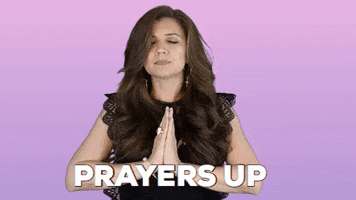 Video gif. A woman with folded hands and closed eyes bows her head. Text, "Prayers up."