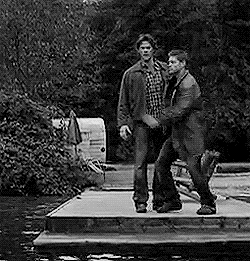 TV gif. Jensen Ackles as Dean gets scared and jumps into the arms of Sam, played by Jared Padalecki, in Supernatural.