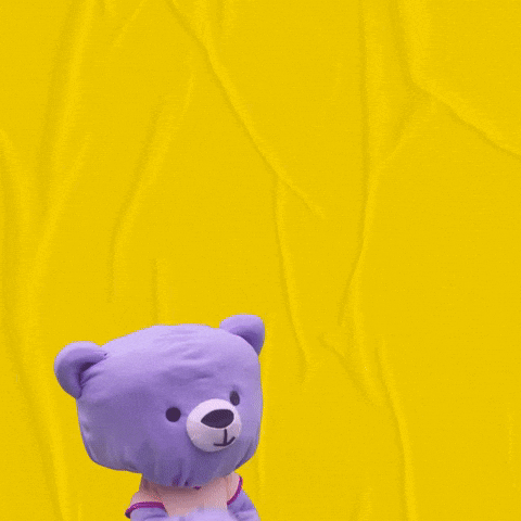 Digital art gif. A stuffed purple teddy bear pops up and kisses its paw. A big white heart appears and the text, “Muah!” after it sends out its kiss.