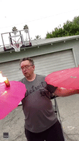 Juggler Uses Flaming Cheeseburger in Parasol Party Trick