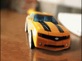 Stop motion gif. A Transformer bumblebee toy is in car mode and then transforms into his robot mode. 