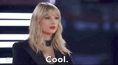 Reality TV gif. Musician Taylor Swift gently nods and says "cool" with a subtle smile on The Voice. 