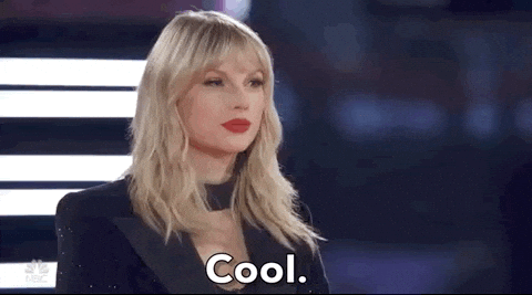 Reality TV gif. Musician Taylor Swift gently nods and says "cool" with a subtle smile on The Voice.