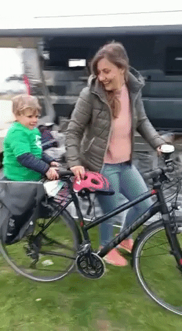 Boy Pushed On Bicycle GIF